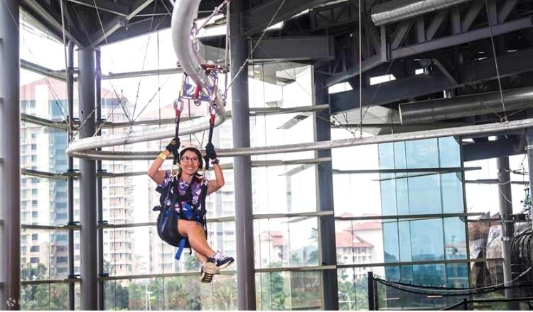 Girl riding on Roller Glider - combination of roller coaster and flying fox