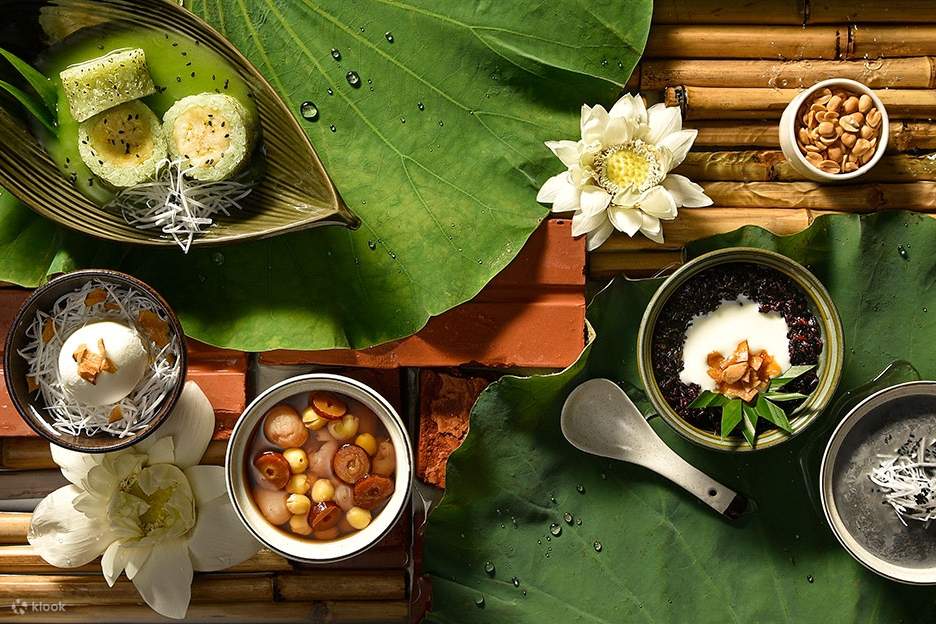 Một bàn ăn với những bát thức ăn và một chiếc lá, thể hiện một bữa ăn ngon miệng và tự nhiên.