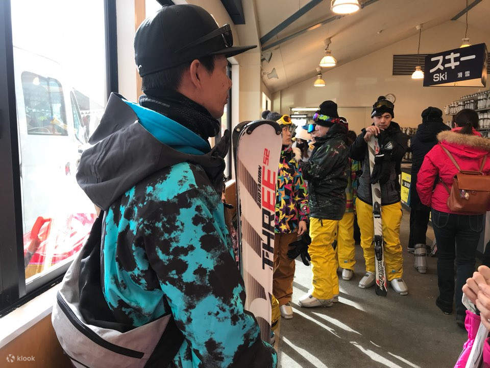 Skiers putting on suits