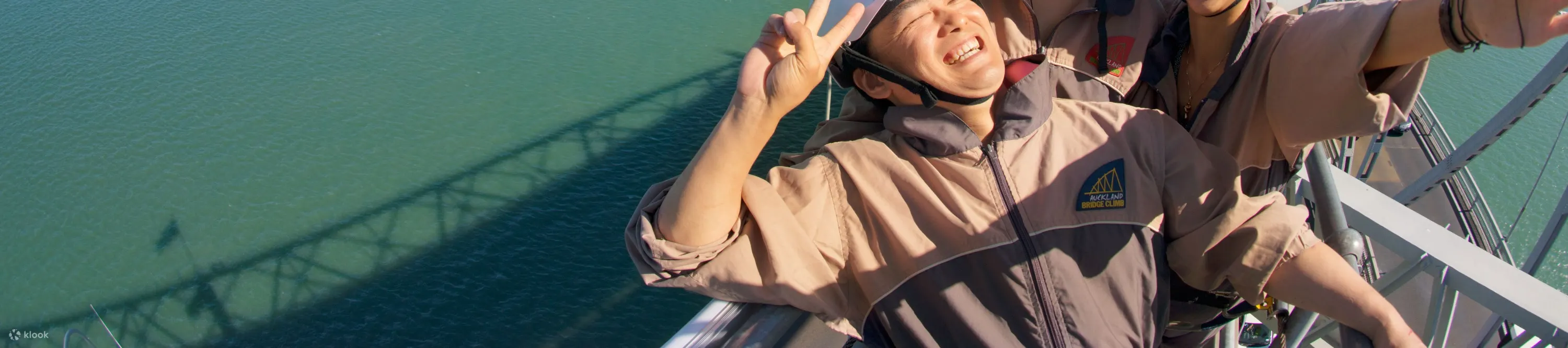 Friends taking selfie on Auckland Harbour Bridge Climb