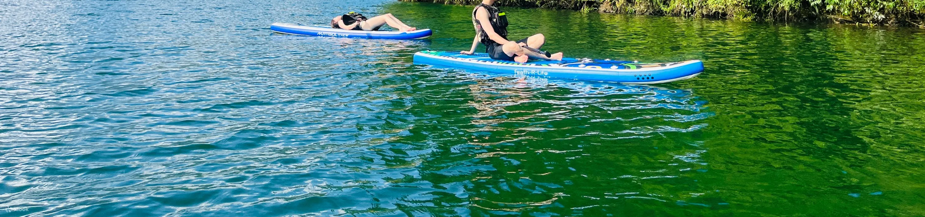 Two people playing sup